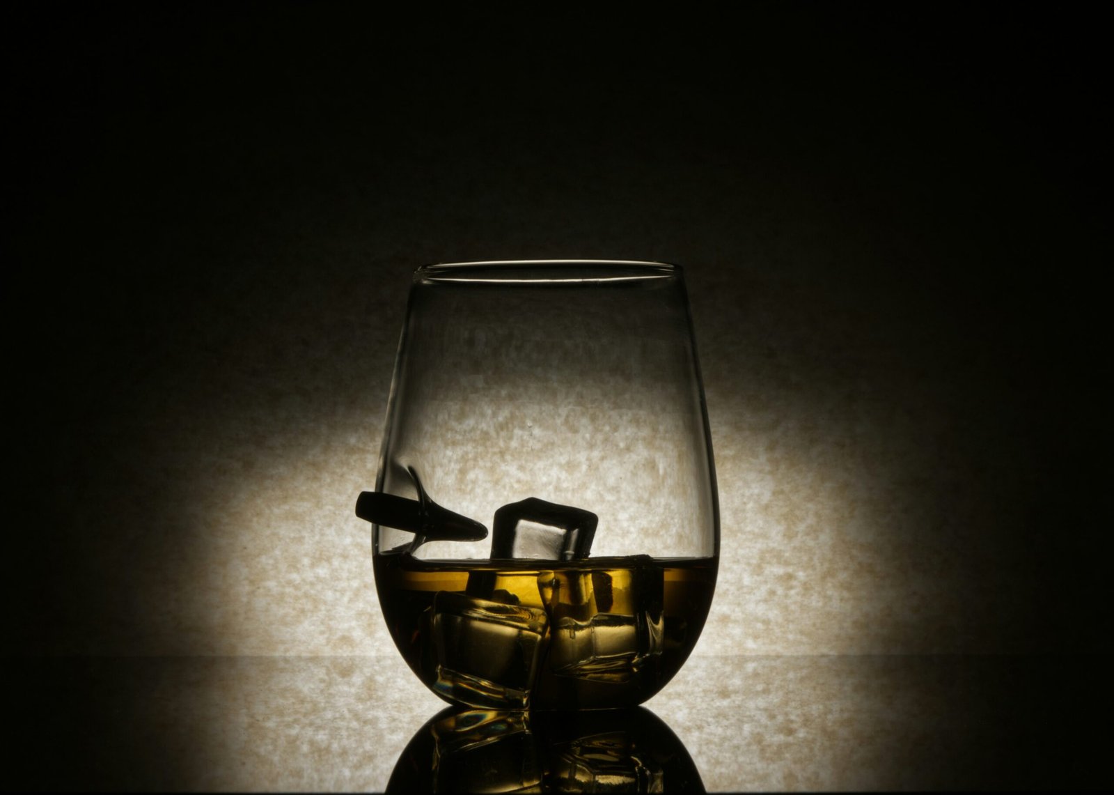 A glass of whiskey sitting on top of a table