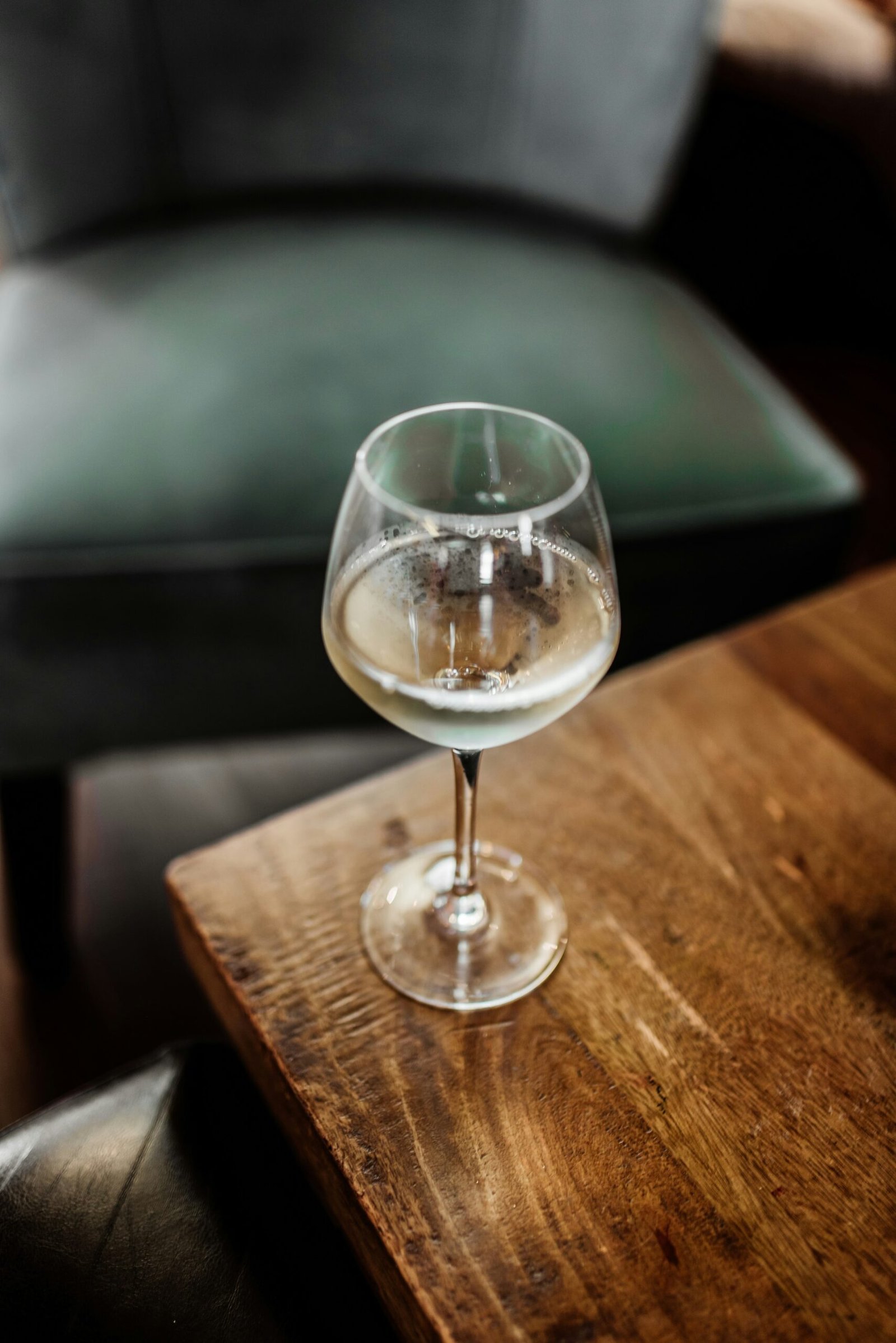 clear wine glass on brown wooden table