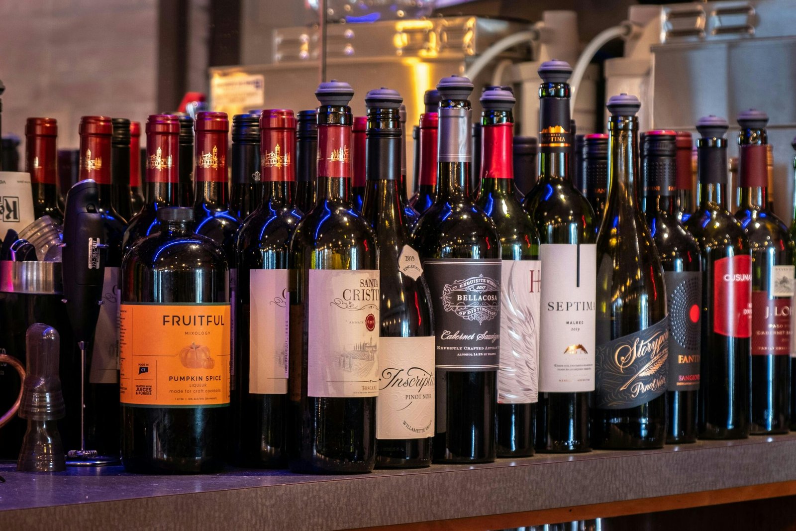 A bunch of bottles of wine sitting on a counter