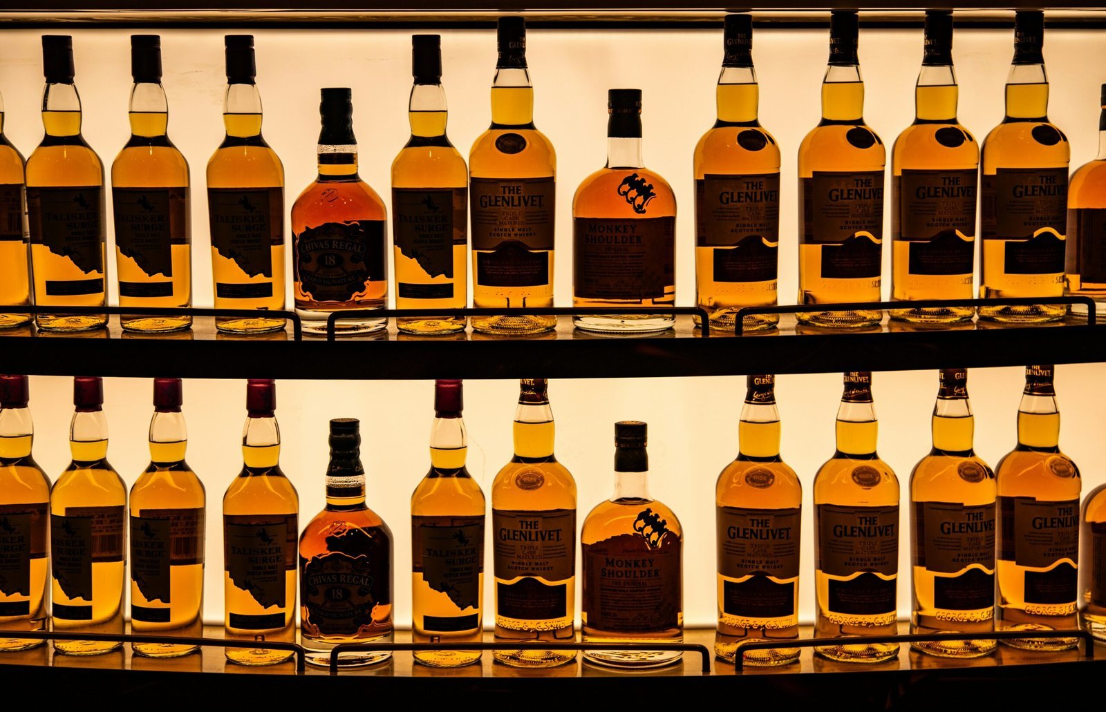 a display of bottles of various types of alcohol